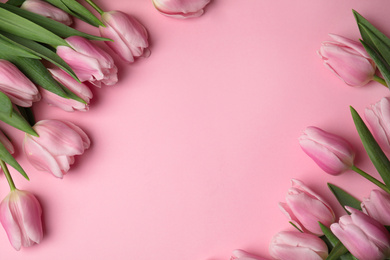 Beautiful spring tulips on light pink background, flat lay. Space for text