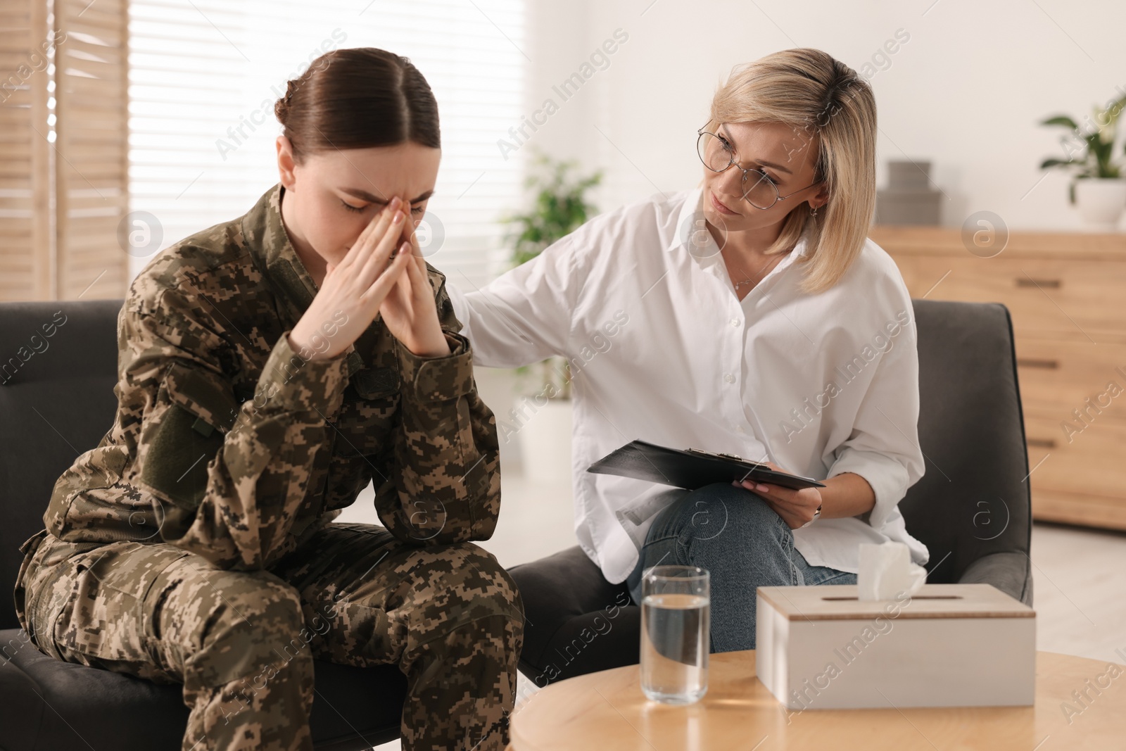 Photo of Psychotherapist working with military woman in office