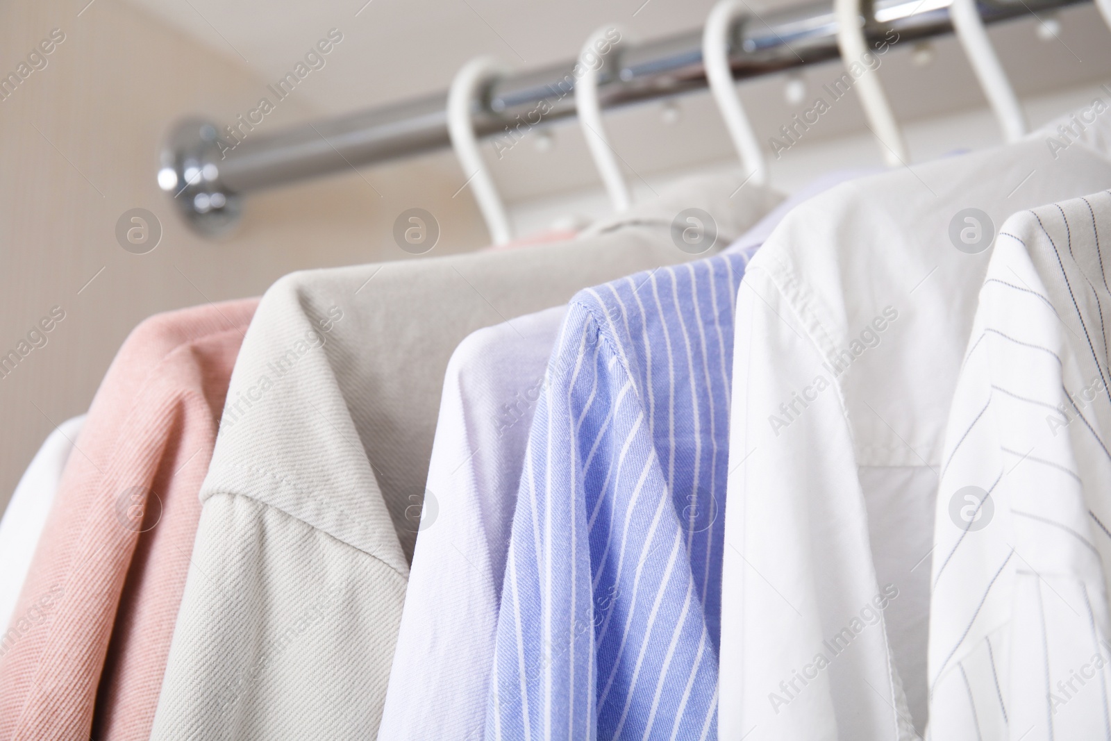 Photo of Collectionclothes in wardrobe, closeup view