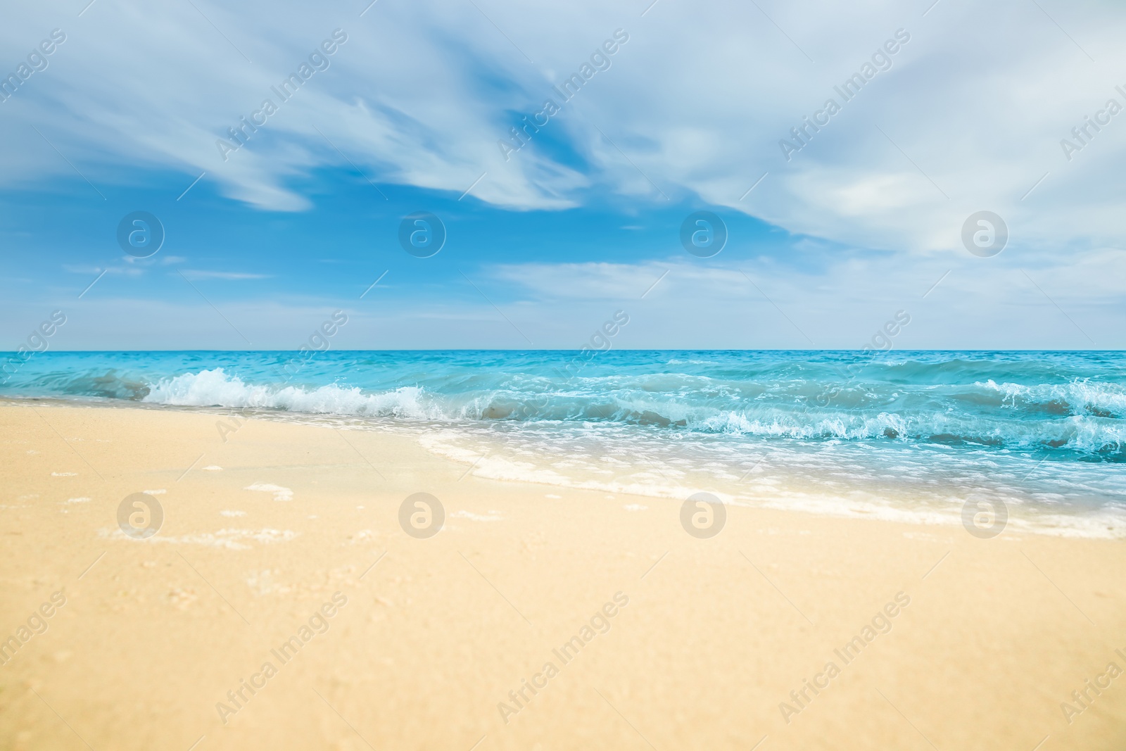 Photo of Sea waves rolling on beautiful sandy beach. Summer vacation