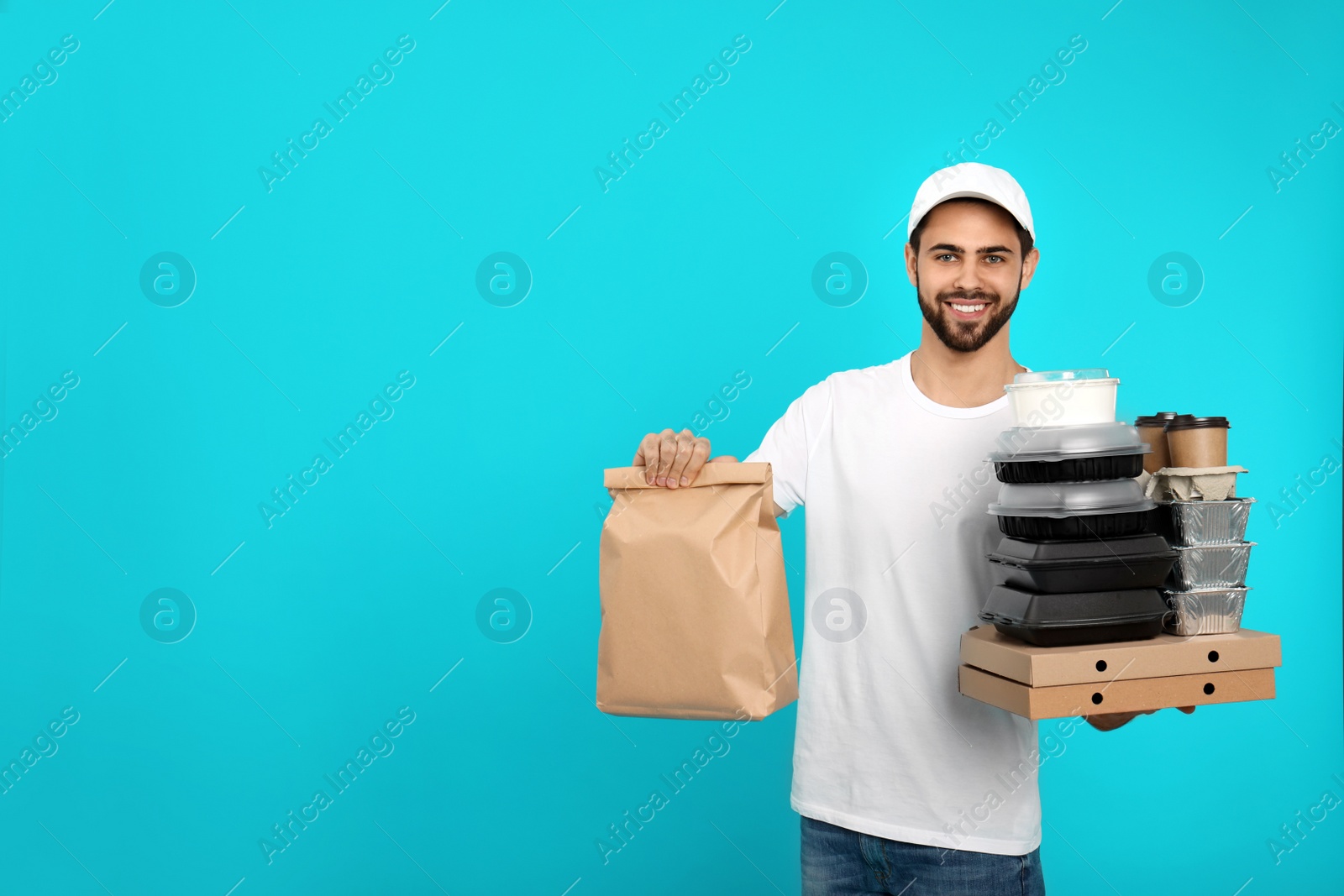 Photo of Young courier with different orders on color background, space for text. Food delivery service