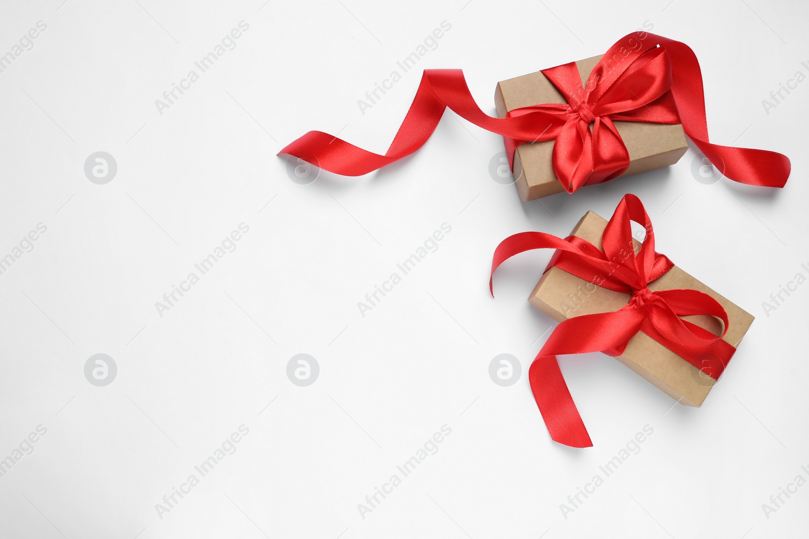 Photo of Beautiful gift boxes on white background, flat lay. Space for text
