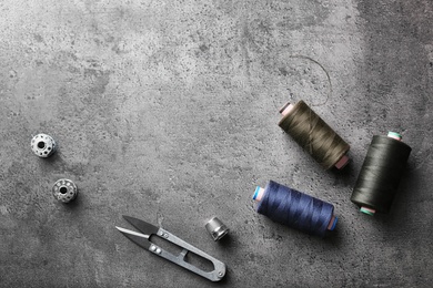 Photo of Composition with accessories for tailoring on grey background