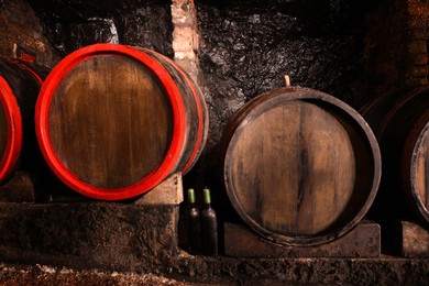 Wooden barrels with alcohol drinks in cellar