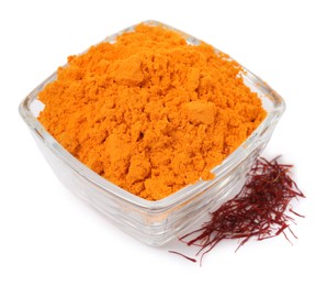 Photo of Bowl with saffron powder and dried flower stigmas on white background