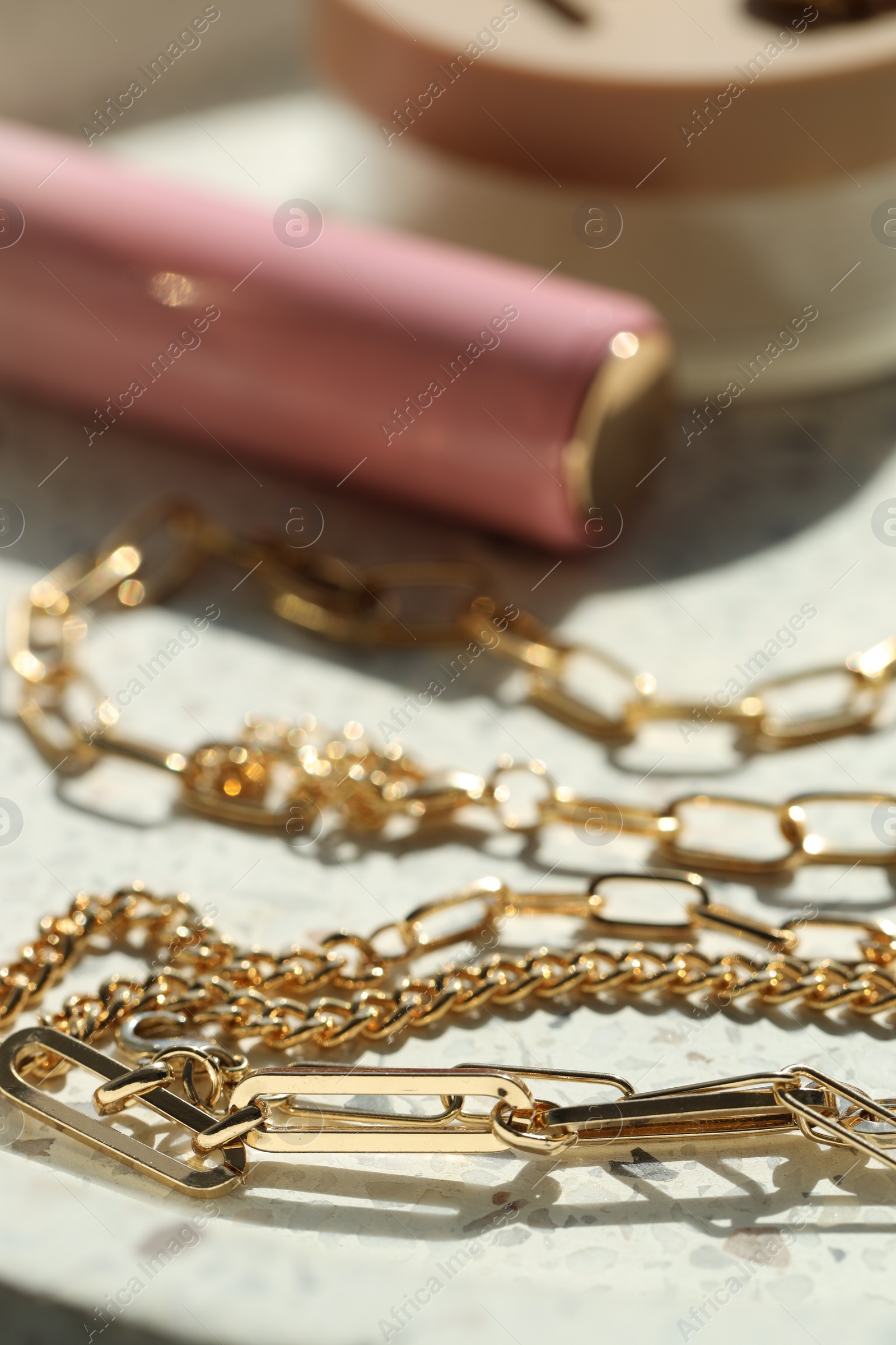 Photo of Metal chains on table, closeup. Luxury jewelry