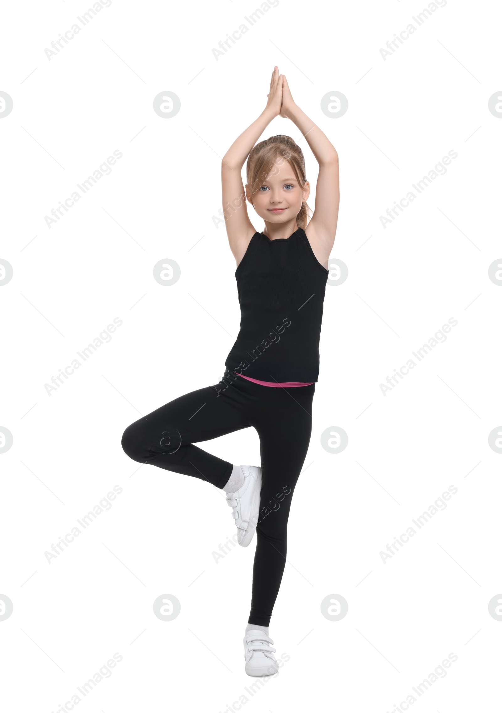 Photo of Little girl doing morning exercise on white background