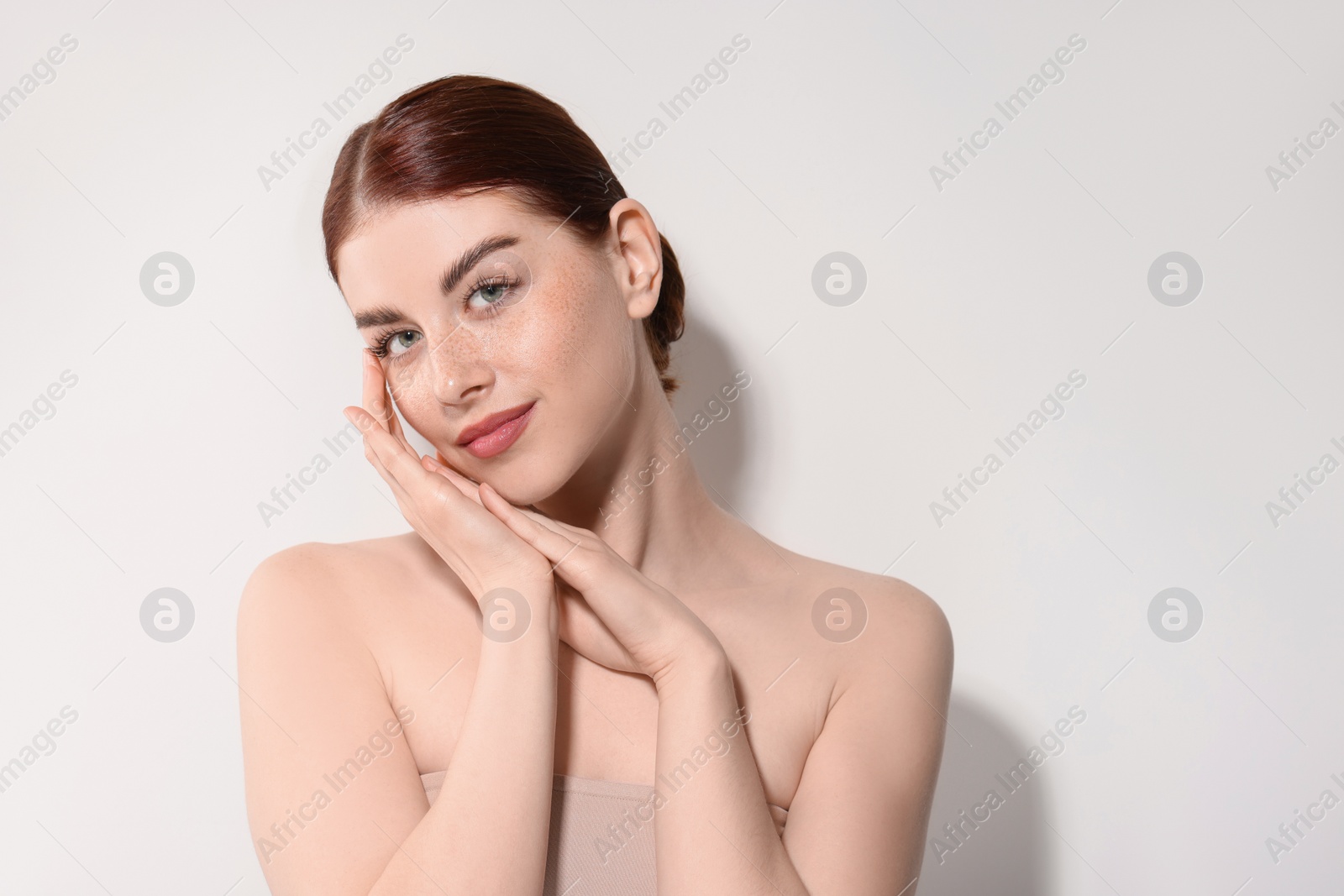 Photo of Portrait of beautiful woman on light background. Space for text