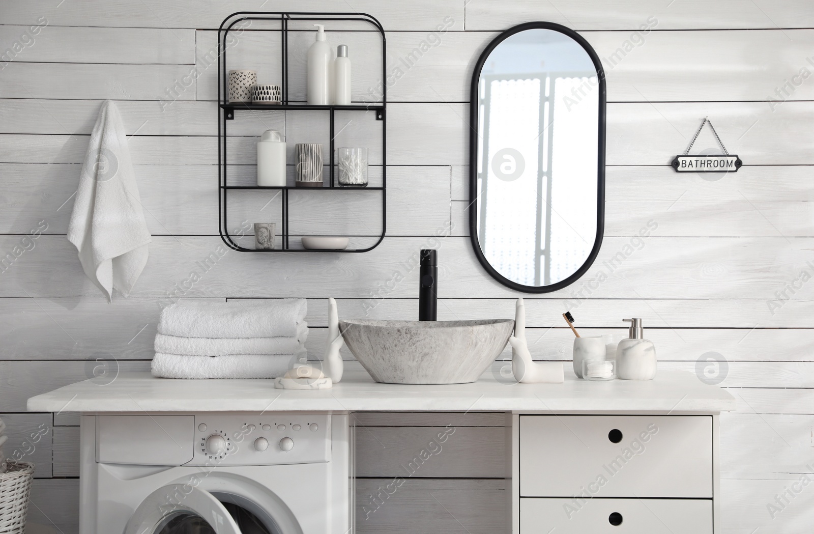 Photo of Stylish bathroom interior with modern washing machine