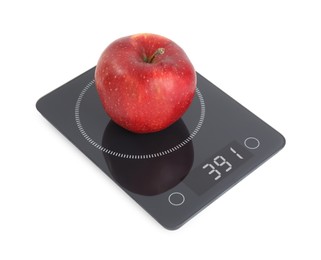 Photo of Ripe red apple and electronic scales on white background