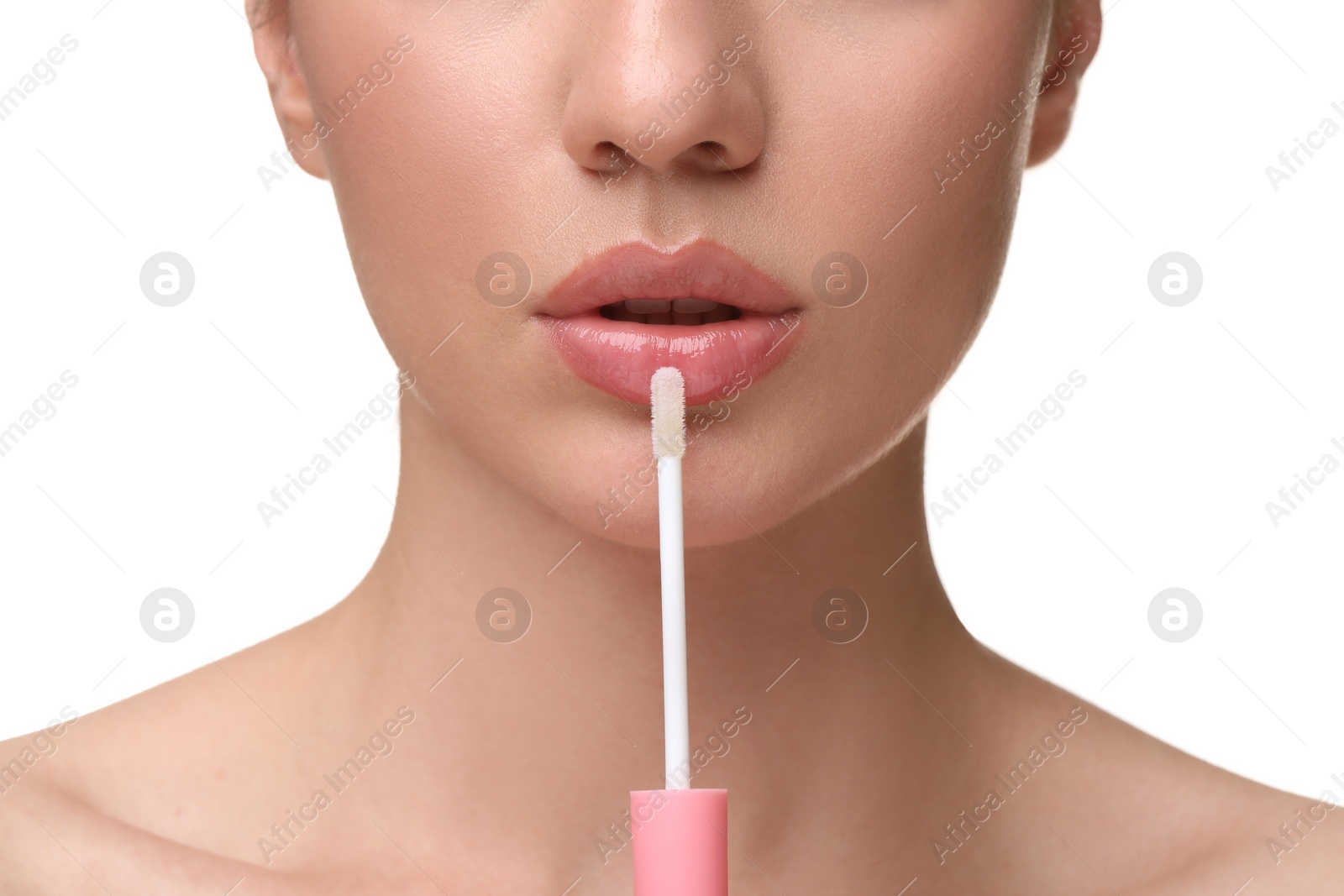 Photo of Woman applying lip gloss on white background, closeup