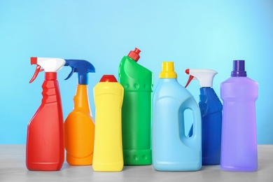 Photo of Bottles of different cleaning products on light table