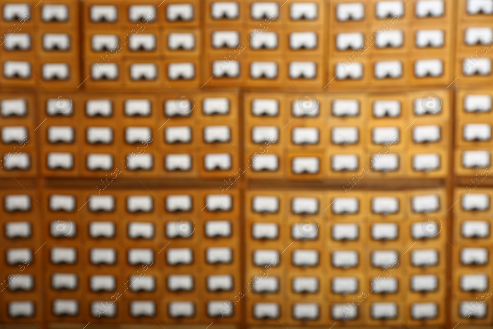 Photo of Blurred view of library card catalog drawers as background