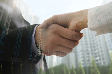 Double exposure of partners shaking hands and cityscape