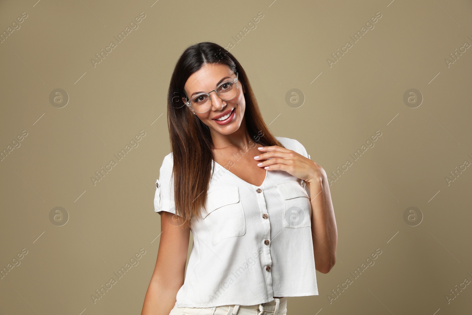 Photo of Beautiful woman in eyeglasses on beige background