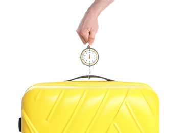 Photo of Man weighing stylish suitcase against white background, closeup