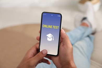 Man using smartphone for online test indoors, closeup