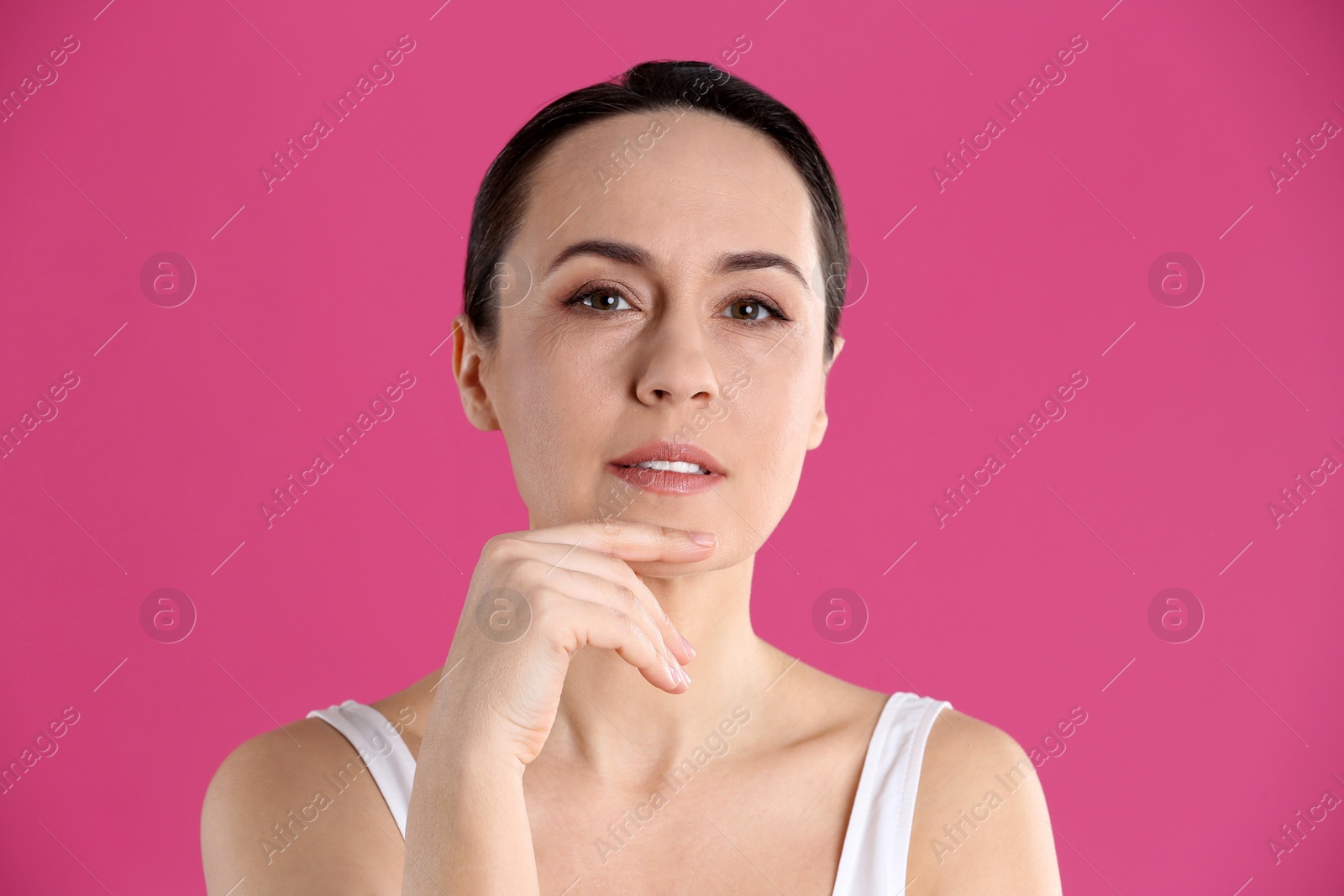 Photo of Portrait of beautiful mature woman on pink background