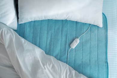 Photo of Bed with electric heating pad, top view