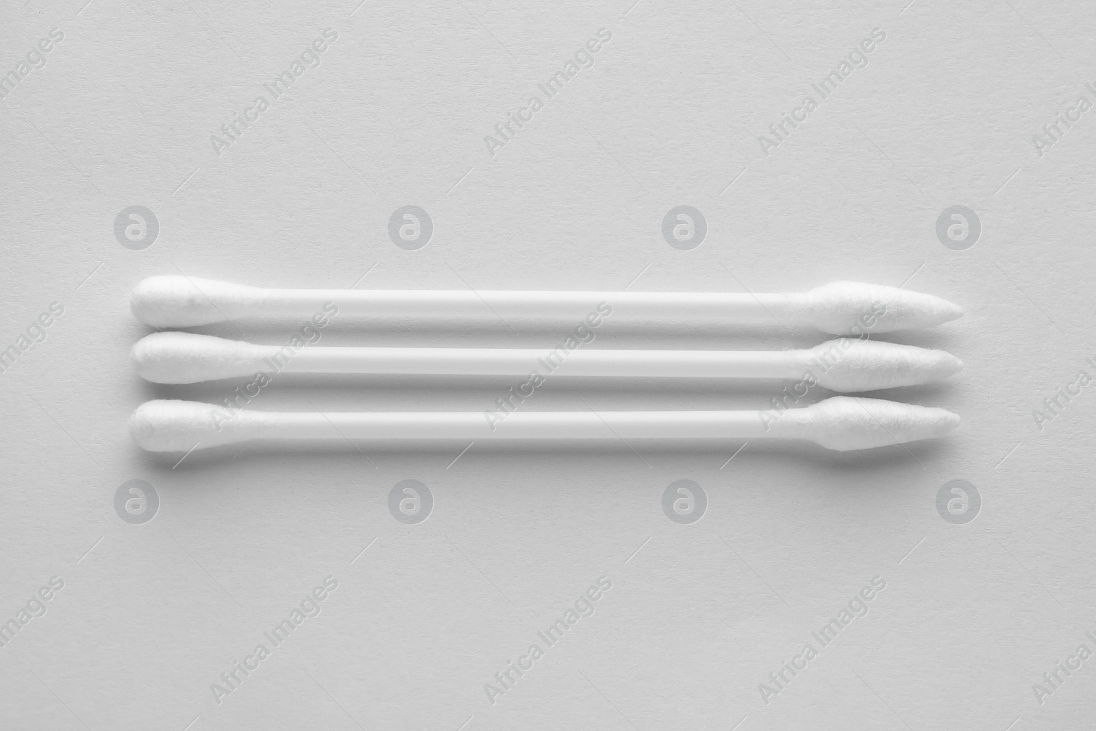 Photo of Clean cotton buds isolated on white, top view