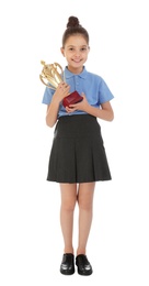 Happy girl in school uniform with golden winning cup isolated on white