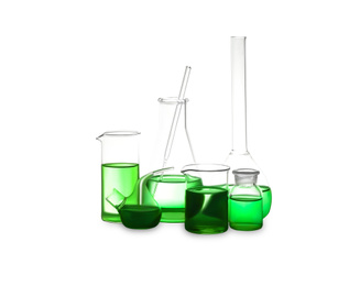 Photo of Different laboratory glassware with light green liquid isolated on white