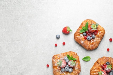 Photo of Fresh delicious puff pastry with sweet berries on light background, flat lay. Space for text