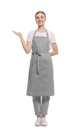 Beautiful young woman in clean apron on white background