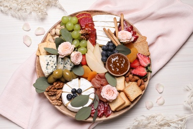 Photo of Assorted appetizers served on white wooden table, flat lay