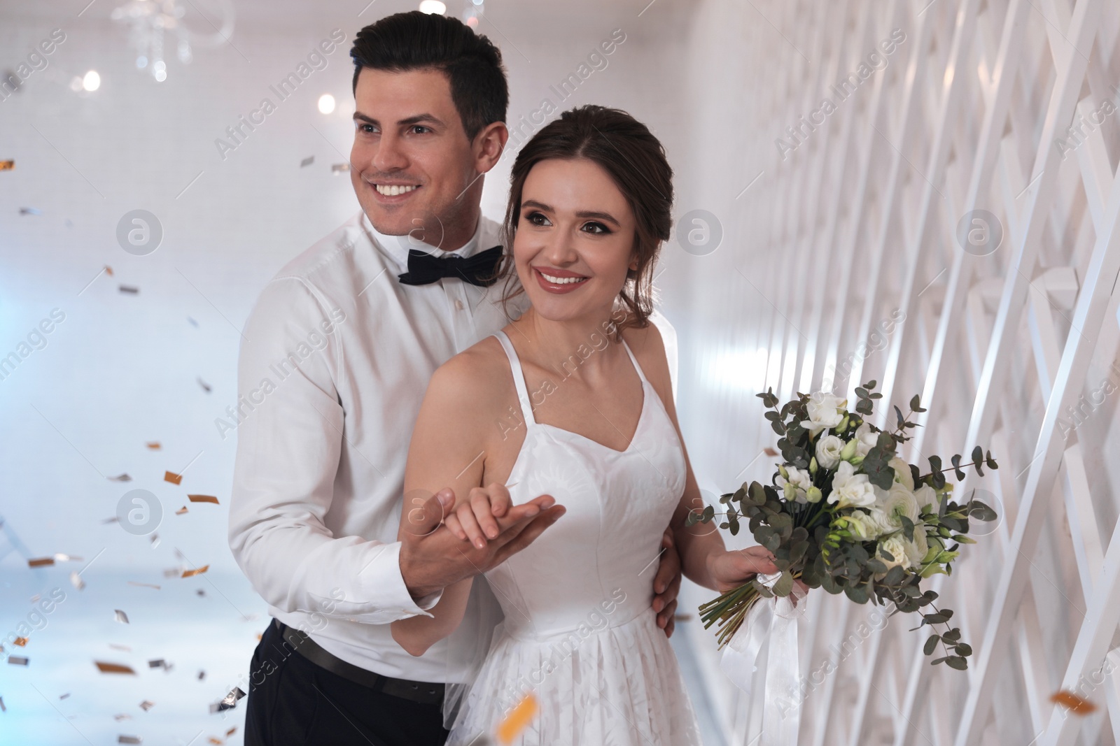 Photo of Happy newlywed couple together in festive hall