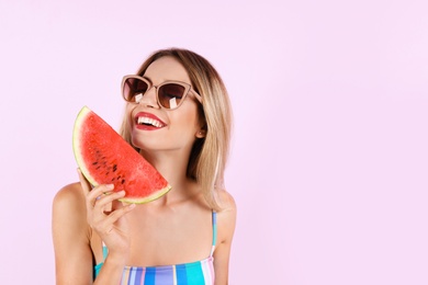 Pretty young woman with juicy watermelon on color background