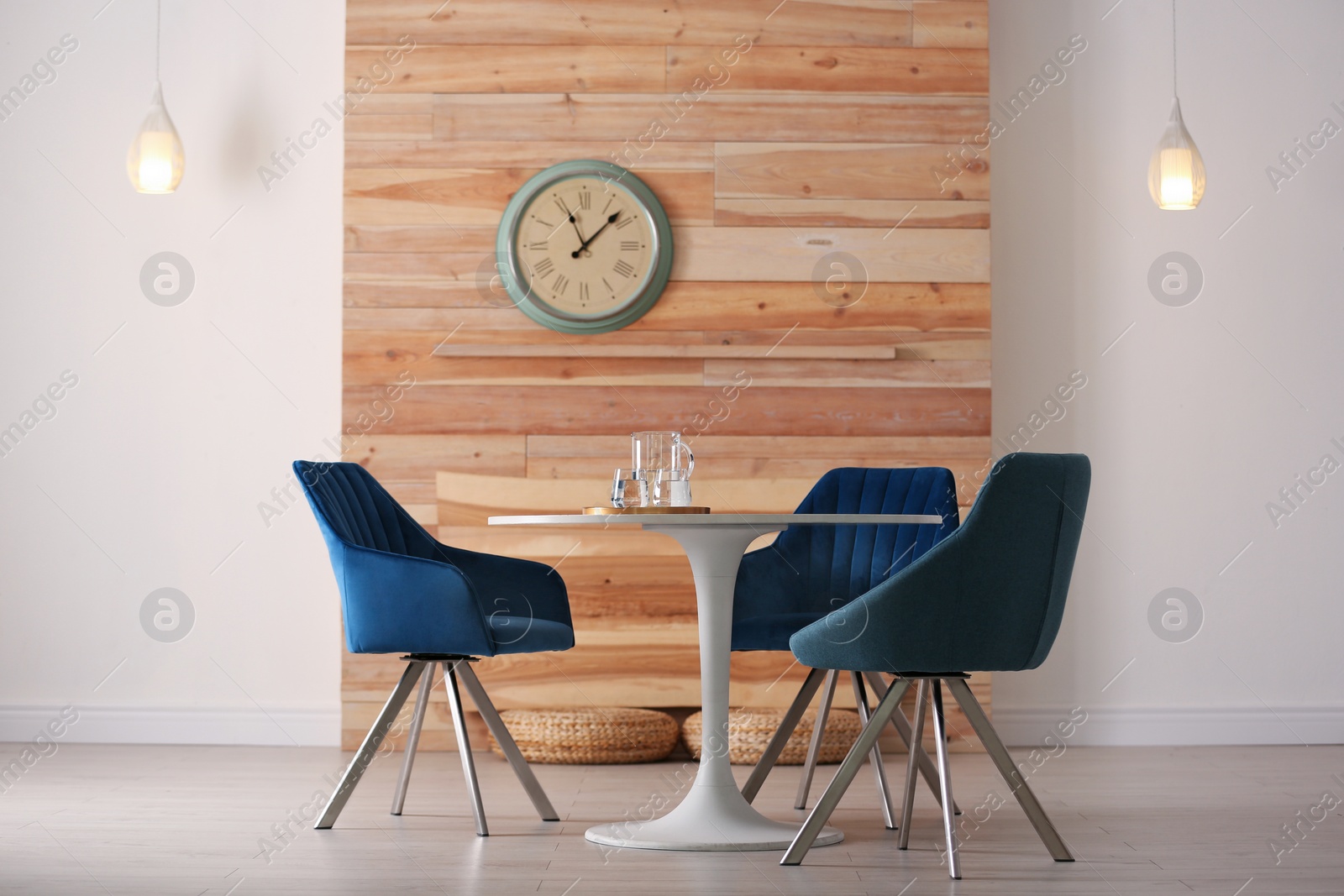 Photo of Stylish room interior with round table and comfortable chairs