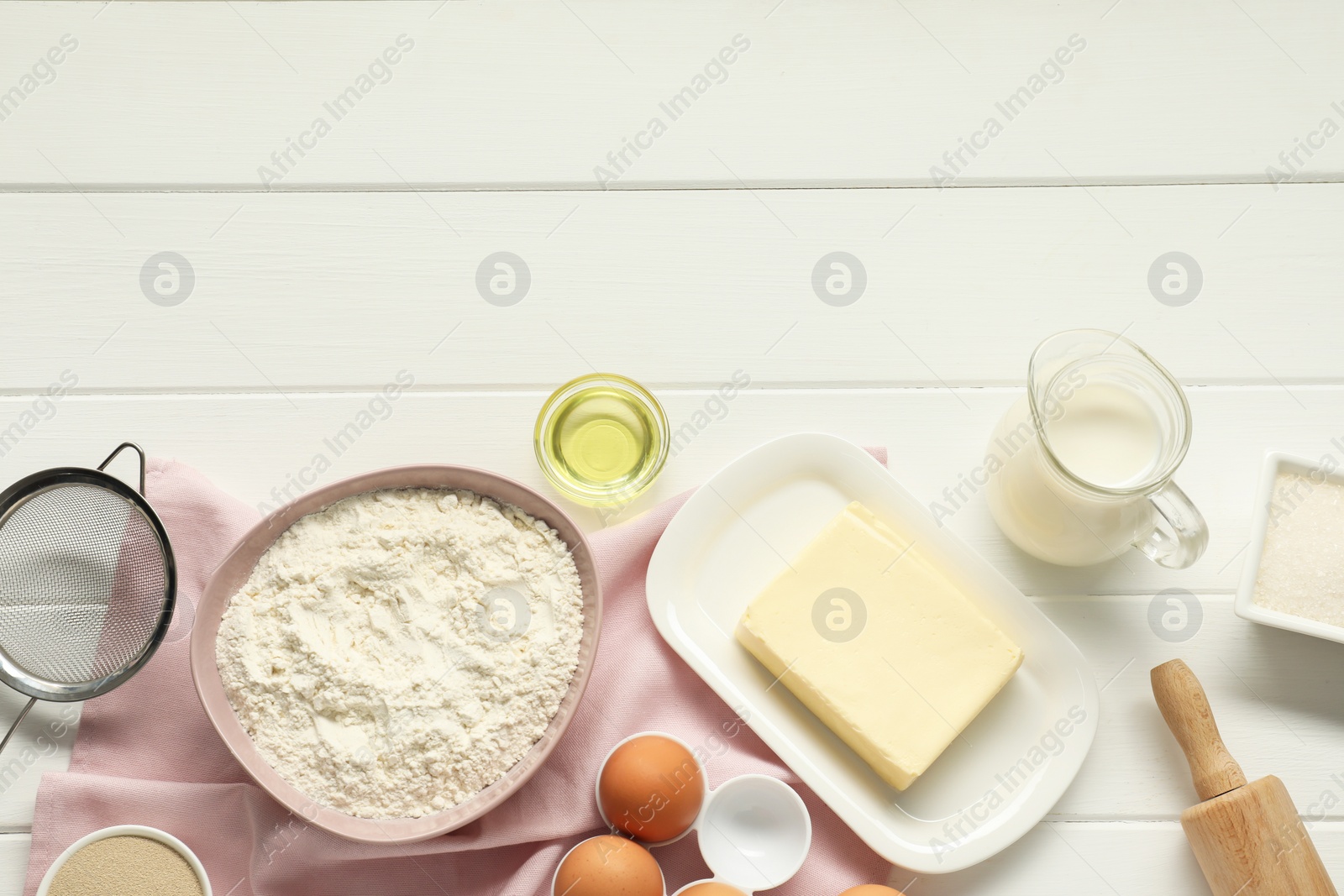 Photo of Flat lay composition with fresh butter and other products on white wooden table. Space for text