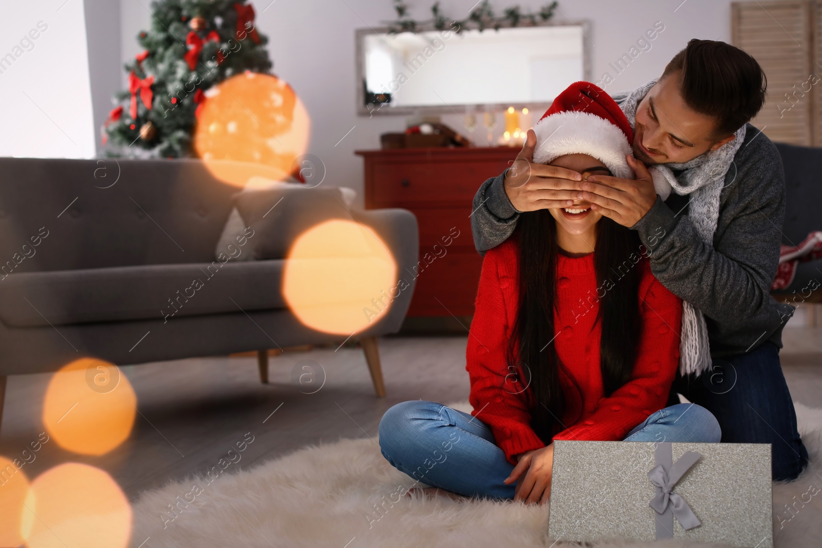 Photo of Happy young couple celebrating Christmas at home