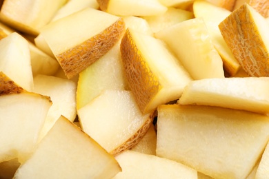 Photo of Pieces of delicious honey melon as background, closeup