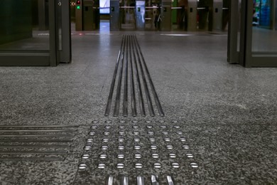 Photo of Floor tiles with tactile ground surface indicators, closeup