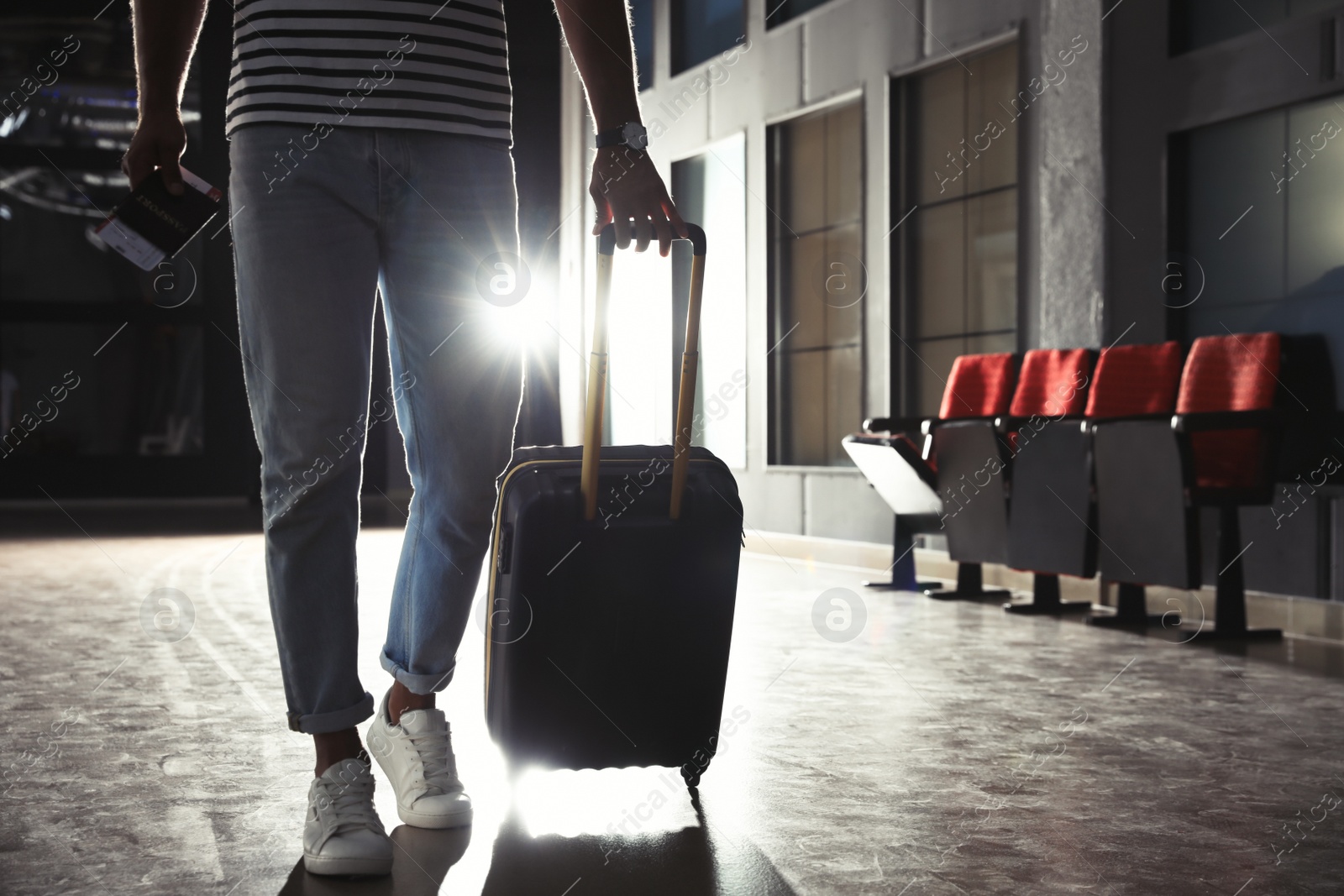 Photo of Man with black travel suitcase in airport