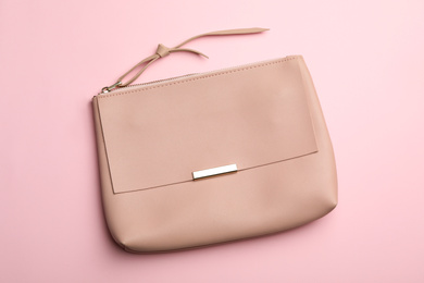 Stylish woman's bag on pink background, top view