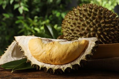 Fresh ripe durian fruits on wooden table