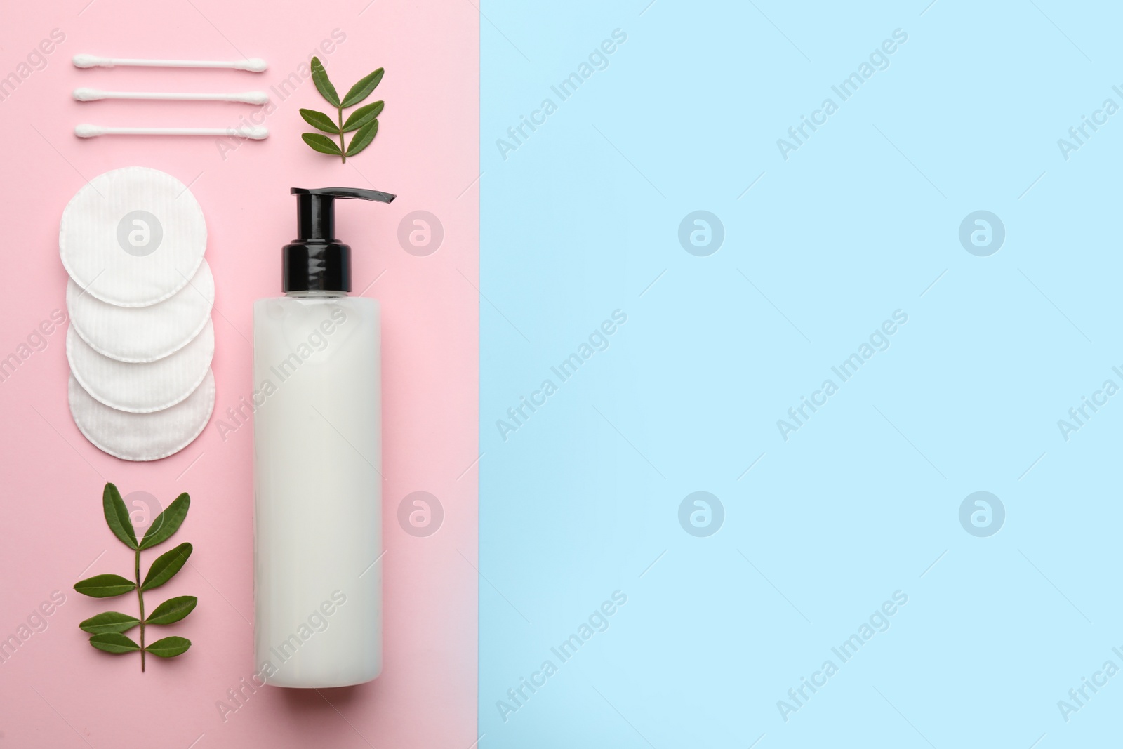 Photo of Cotton pads, swabs, leaves and makeup removal product on color background, flat lay. Space for text