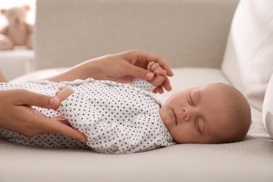 Photo of Mother with her cute sleeping baby at home, closeup