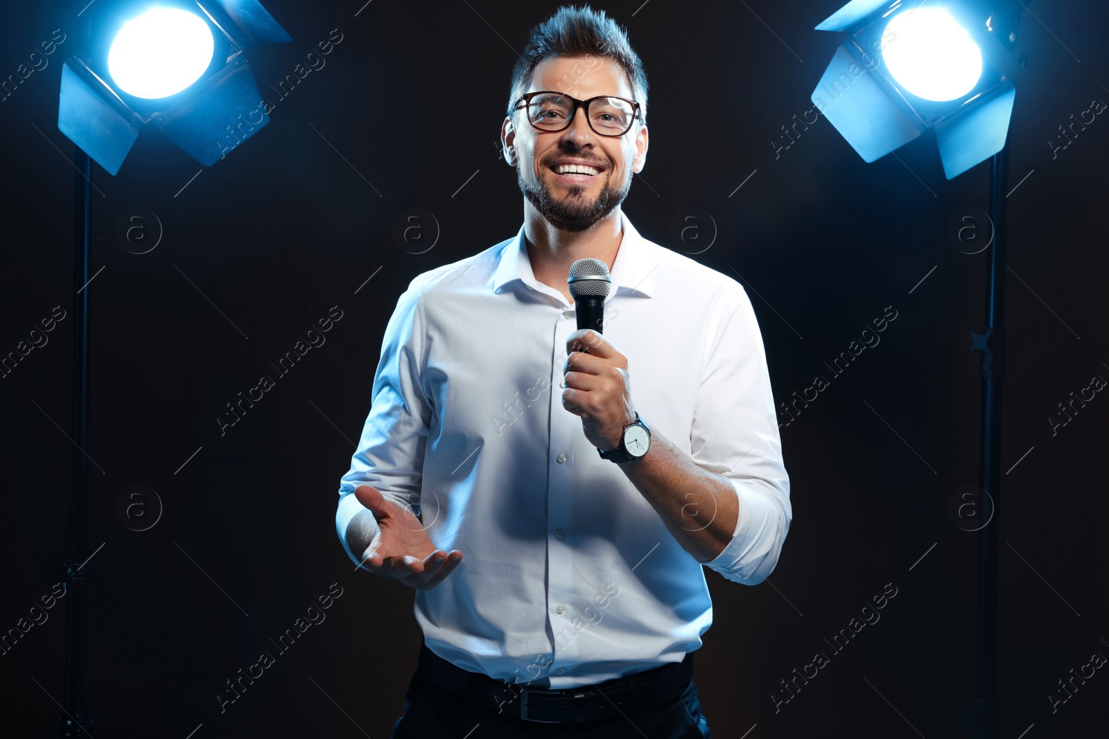 Photo of Motivational speaker with microphone performing on stage