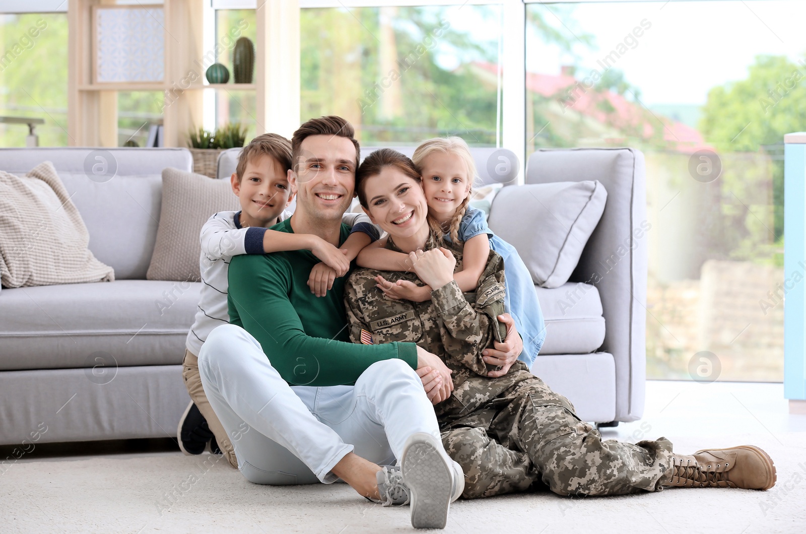 Photo of Woman in military uniform with her family at home