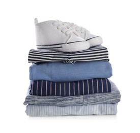 Photo of Stack of clean baby's clothes and small shoes on white background