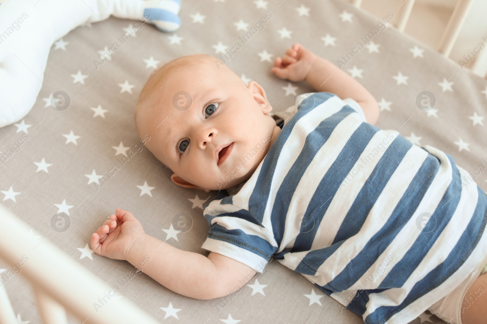 Photo of Cute little baby lying in crib. Sleeping time