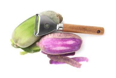 Photo of Daikon radishes and peeler isolated on white, top view