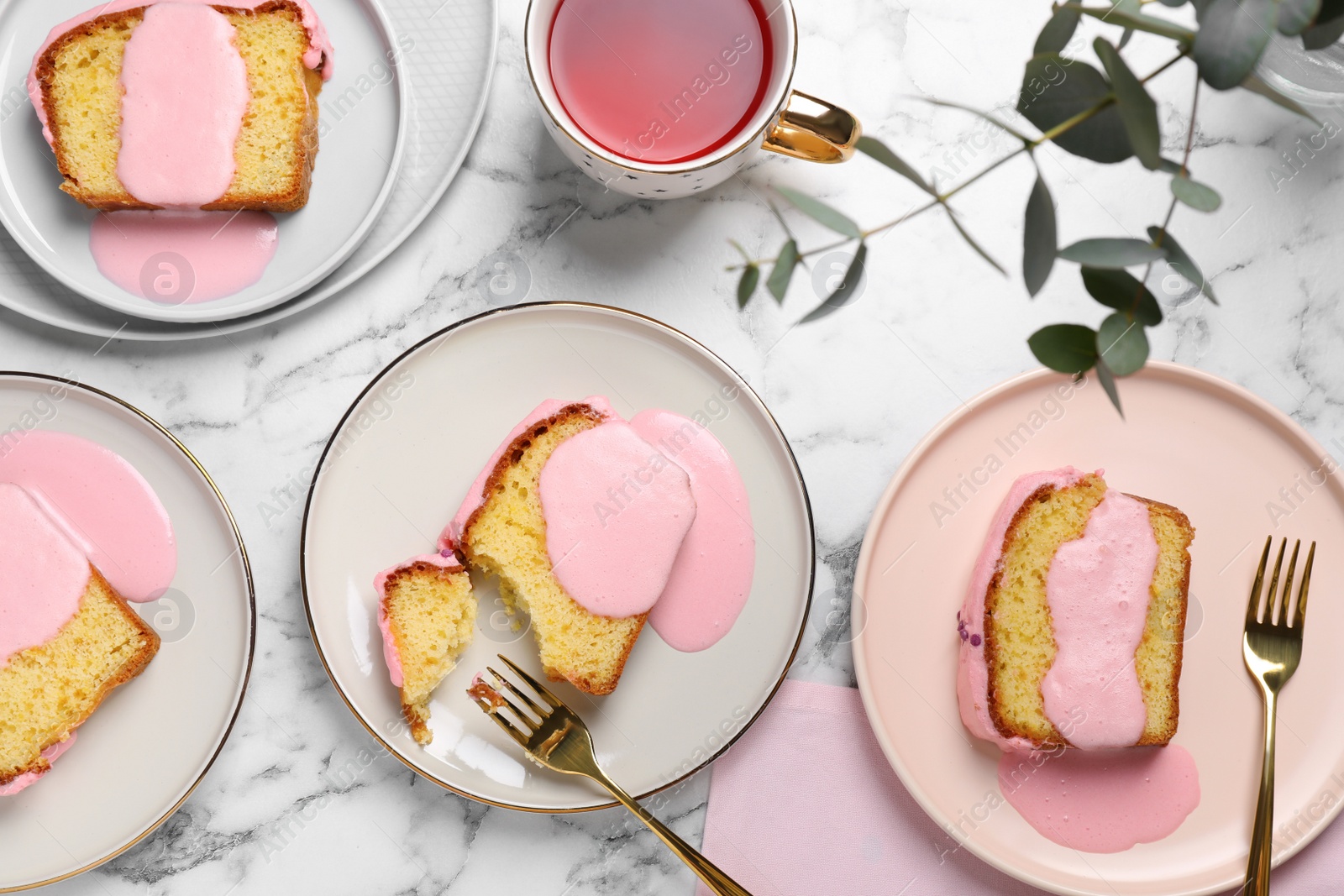 Photo of Delicious cake with pink glaze served on white marble table, flat lay