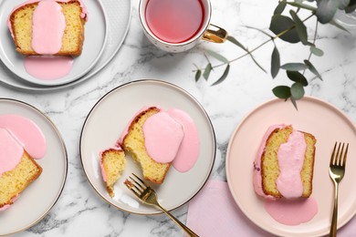 Photo of Delicious cake with pink glaze served on white marble table, flat lay