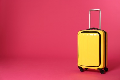 Photo of Stylish suitcase on color background. Space for text