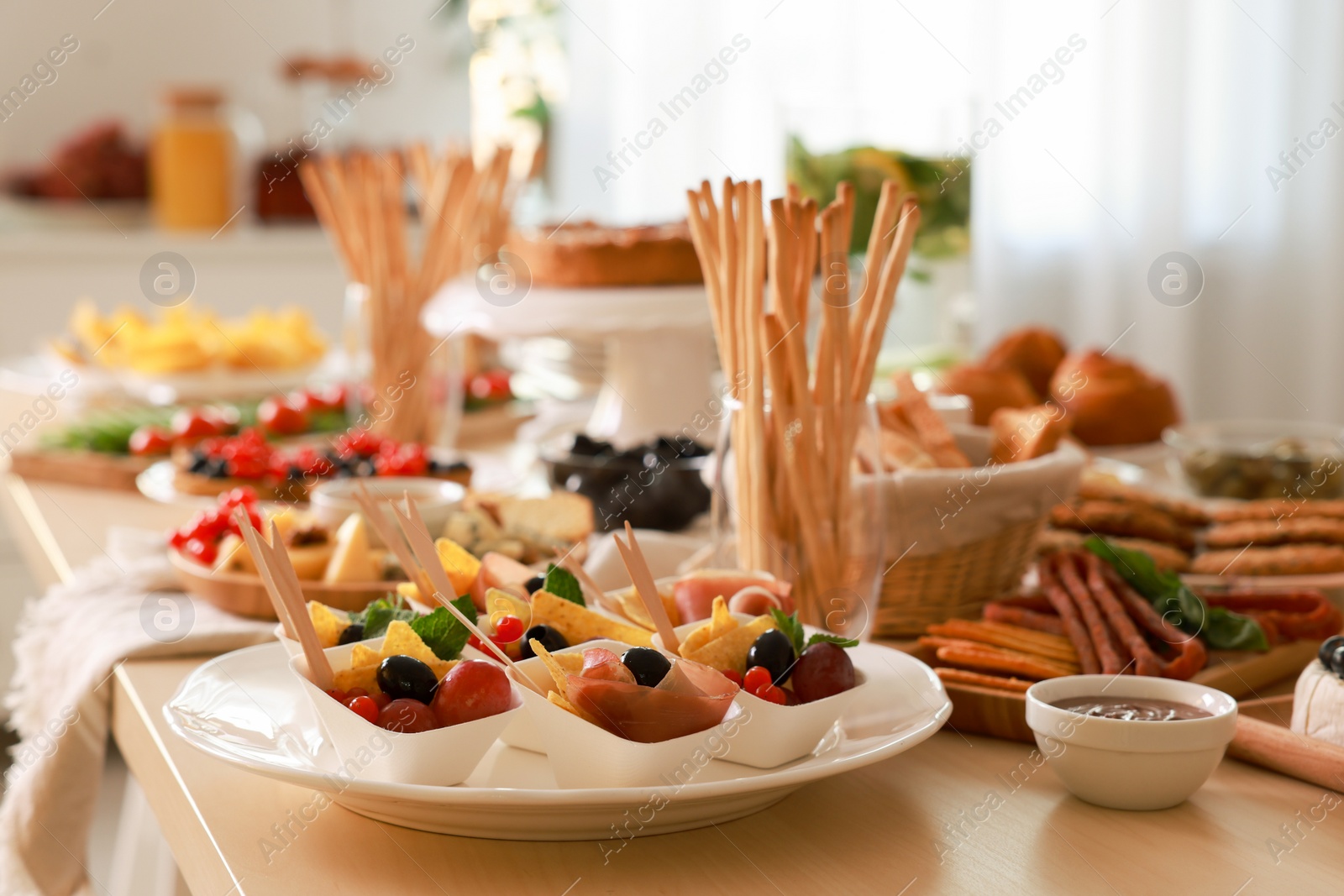 Photo of Dishes with different food on table in room. Luxury brunch